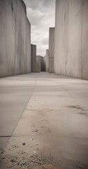 Fototapete - A long, narrow concrete corridor stretches out, flanked by towering gray walls on either side The floor is a uniform gray, with small cracks and stains, and the sky above