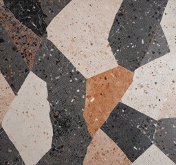 Fototapete - a close-up view mosaic tile pattern composed of irregularly shaped tiles in various shades of gray, black, and beige, with some areas featuring a speckled or