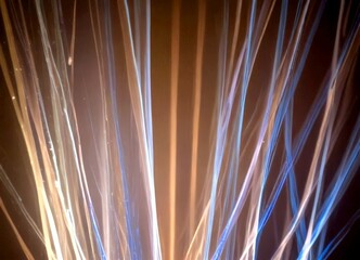 Poster - a close-up view fireworks display, with vibrant blue and white streaks of light against a dark background