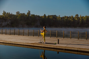 A Morning Runner Enjoys a Peaceful Run by the Serene Lake Surrounded by Scenic Landscape