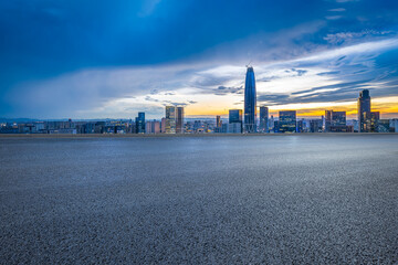 Wall Mural - Empty asphalt road and cityscape with skyline in modern city at sunset