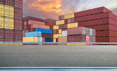 Aufkleber - Stacked containers and empty asphalt road in port at sunset
