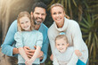 © peopleimages.com - Family, outdoor portrait and garden for care in nature, support children and backyard of home. Parents, kids and embrace on grass for bonding in environment, Switzerland and happiness in relationship