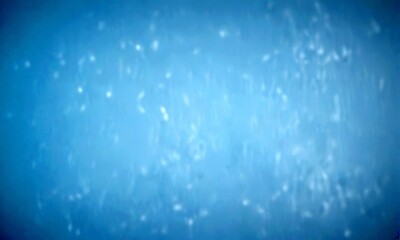 Aufkleber - a blurred, hazy blue background with small white specks scattered throughout, creating a sense of movement and depth