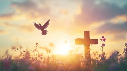 Silhouette of a cross and a dove flying at sunset in a field of wildflowers.