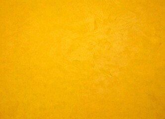 Aufkleber - a close-up view textured yellow surface, possibly a wall or a piece of paper, with a subtle pattern or design