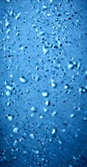 Poster - a close-up view textured surface with numerous small, round water droplets scattered across it, creating a sense of depth and texture