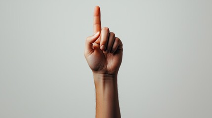 Hand raised with index finger pointing upwards, white isolated background.