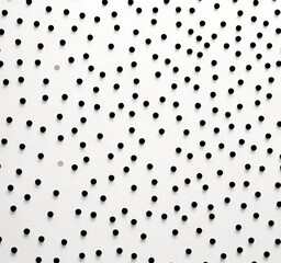Poster - a close-up view white background with numerous black dots scattered across it, creating a visually striking pattern