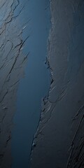 Poster - a close-up view textured surface with a dark blue color, featuring a vertical crack running through it