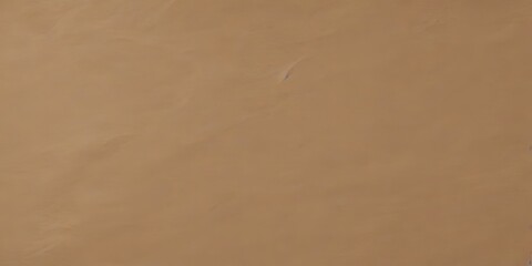 Aufkleber - a close-up view of a brown, textured surface, possibly a piece of paper or fabric, with a faint outline of a blue line or shape in the center.