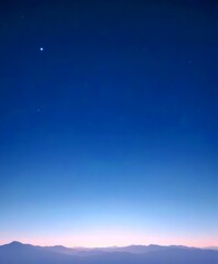 Poster - A serene night sky with a few stars and a bright moon, set over a mountainous landscape with a gradient of colors from blue to orange