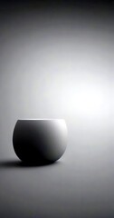 Leinwandbilder - A minimalist gray bowl sits on a gray surface, its smooth surface reflecting the light