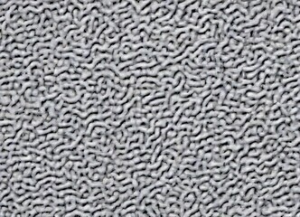 Aufkleber - a close-up view of a textured surface, resembling a fuzzy or fuzzy-looking fabric or material. The surface has a grayish-white color and appears to be made of a material that