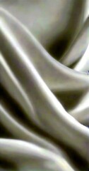 Aufkleber - a close-up view white fabric, possibly a sheet or a curtain, with a soft, flowing texture The fabric appears to be made smooth, silky material, giving it a