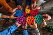 © Edgar Martirosyan - A group of people holding colorful gears in their hands, a collaboration and success concept.