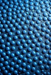 Fototapete - A close-up view textured surface with a repeating pattern of blue and white spheres, creating a visually striking and abstract design
