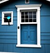 © Bualong - A blue house with a white door and window frame, featuring a blue door knocker and a blue circular window decoration
