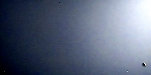 Poster - a dark gray background with a small, white, triangular shape in the bottom right corner