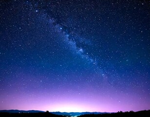 Poster - The Milky Way stretches across the night sky, its spiral arms visible against the backdrop starry sky and a distant horizon