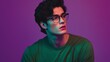 © atipong - Confident Young Man with Dark Hair and Glasses in Green Shirt Against Purple Background Stylish Pose Cool Vibes Ideal for Lifestyle Fashion or Modern Marketing Themes