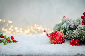 Wall Mural - christmas holiday background with snow, fir tree and decorations with christmas light behind. christ