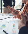 © Kritdanai - Business Meeting Applause: A close-up shot of a diverse group of business professionals clapping their hands in a meeting, showcasing the positive energy and camaraderie within their workplace.