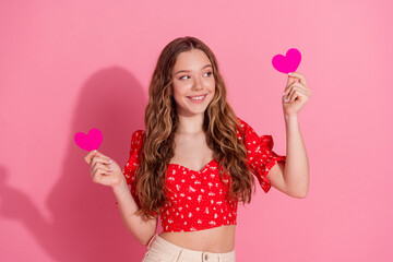 Wall Mural - Photo portrait of pretty teen girl look hold heart postcards wear trendy red outfit isolated on pink color background