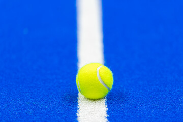 Canvas Print - Paddle tennis and tennis ball on blue court. Horizontal sport poster, greeting cards, headers, website.