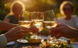 © kkkiim graphic - Friends Toasting with White Wine at an Outdoor Table During Golden Hour