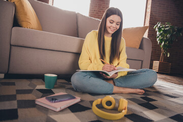 Poster - Full size photo of attractive teen woman sit floor do homework textbook dressed yellow outfit cozy day light home interior living room