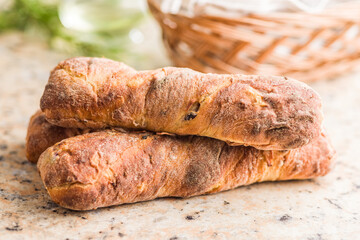 Canvas Print - Crusty rustic baguette on kitchen table.