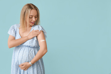 Canvas Print - Young pregnant woman after vaccination on blue background