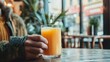 © Jakkarin - Social Hydration: Person Blissfully Sipping Fresh Juice at Cafe