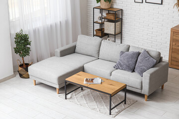 Sticker - Stylish interior of living room with comfortable sofa, coffee table and shelving unit