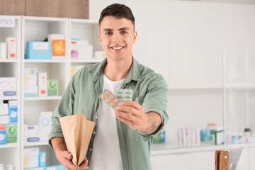 Wall Mural - Male customer with his order at pharmacy