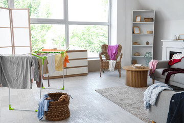 Sticker - Interior of living room with dryer and dirty laundry on sofas