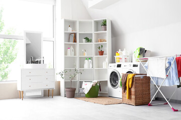 Canvas Print - Interior of light bathroom with washing machines, laundry basket and dryer