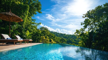 Wall Mural - stunning tropical pool with lounge chairs overlooking lush greenery and blue sky.