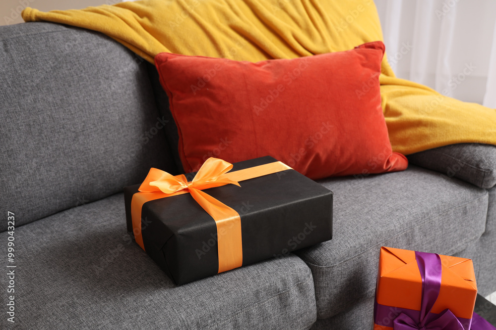 Gift boxes on sofa in living room. Closeup