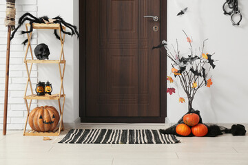 Wall Mural - Wooden door and Halloween decorations with paper bats, broom and fetters in interior of hallway