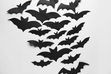 Black paper bats for Halloween party on grey background