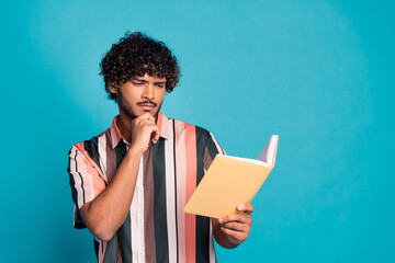 Canvas Print - Portrait of nice young man read book think wear shirt isolated on turquoise color background