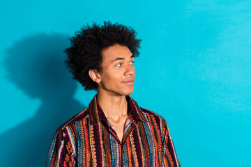 Wall Mural - Photo portrait of young funky guy with curly hair wearing striped shirt curious looking for summer clothing sale isolated on cyan color background