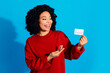 © deagreez - Photo portrait of lovely young lady point look credit card dressed stylish red garment isolated on blue color background