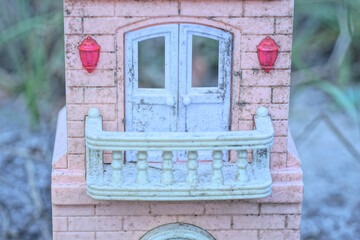 Sticker - part of old one plastic toy house with white balcony and door on pink wall