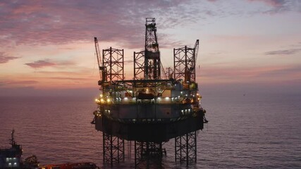 Wall Mural - Aerial view of an offshore jack up drilling rig during sunset - oil and gas upstream industry
