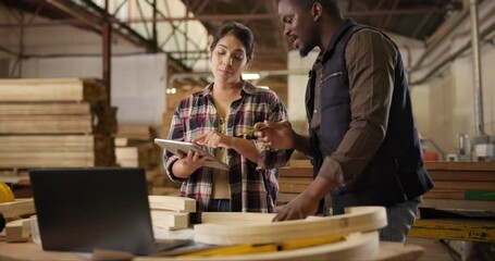 Canvas Print - Teamwork, carpenter and laptop in workshop, discussion and designer furniture manufacturing. Mentorship, man and woman for collaboration, brainstorming and support with touchscreen for job project