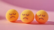 © Ice Cream Paradise - emotional, mood, grumpy concept: three yellow balls with frowning, irritated faces arranged in a tight, slightly overlapping pattern against an isolated soft pink background