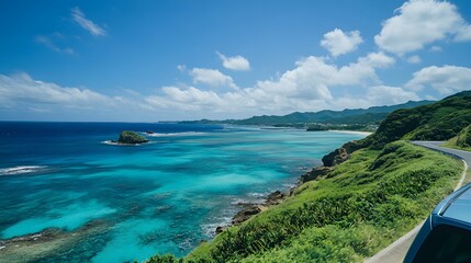 A scenic coastal road with turquoise water, green hills, and a clear blue sky.